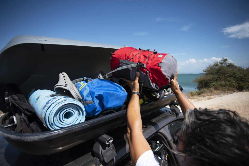 Man Packing Roof Box On Holiday